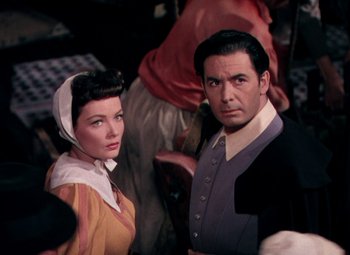 Movie still from “Plymouth Adventure” (1952), directed by Clarence Brown – A man and a woman standing next to each other; Medium shot, Low angle