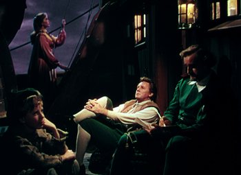 Movie still from “Plymouth Adventure” (1952), directed by Clarence Brown – A group of people sitting in a room; Wide shot, High angle