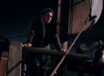 Movie still from “Plymouth Adventure” (1952), directed by Clarence Brown – A man standing on top of a wooden structure; Medium shot, Low angle