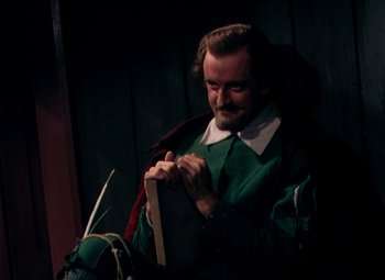 Movie still from “Plymouth Adventure” (1952), directed by Clarence Brown – A man in a green shirt and a green tie; Medium shot, High angle