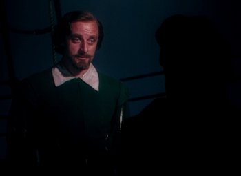 Movie still from “Plymouth Adventure” (1952), directed by Clarence Brown – A man in a green shirt is looking at a man in a white shirt; Medium shot, Over the shoulder angle