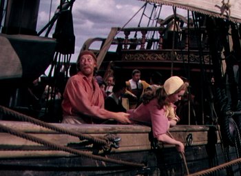 Movie still from “Plymouth Adventure” (1952), directed by Clarence Brown – A man and a woman sitting on a boat; Medium shot, High angle