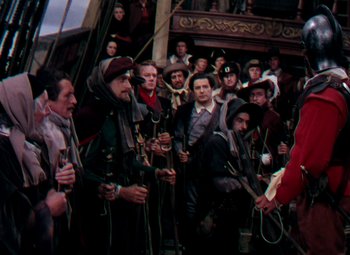 Movie still from “Plymouth Adventure” (1952), directed by Clarence Brown – A group of men standing next to each other on a boat; Wide shot, Over the shoulder angle