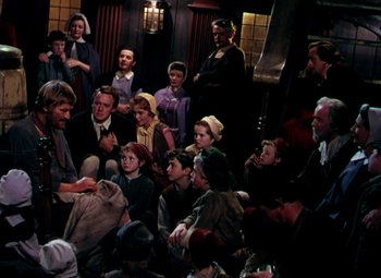 Movie still from “Plymouth Adventure” (1952), directed by Clarence Brown – A group of people sitting in a room; Wide shot, High angle