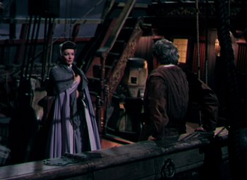 Movie still from “Plymouth Adventure” (1952), directed by Clarence Brown – A man and a woman are standing on a boat; Wide shot, High angle