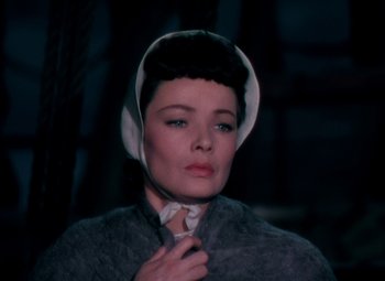 Movie still from “Plymouth Adventure” (1952), directed by Clarence Brown – A woman wearing a neck tie and a gray jacket; Close Up shot, High angle