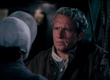 Movie still from “Plymouth Adventure” (1952), directed by Clarence Brown – An older man in a brown jacket looking at another man in a white hat; Close Up shot, Over the shoulder angle