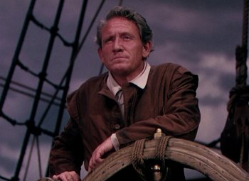 Movie still from “Plymouth Adventure” (1952), directed by Clarence Brown – A man standing on top of a boat in the water; Close Up shot, Low angle