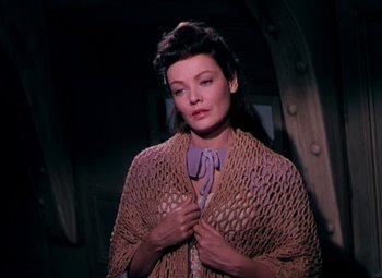 Movie still from “Plymouth Adventure” (1952), directed by Clarence Brown – A woman in a brown sweater holding a purple bow tie; Close Up shot, High angle