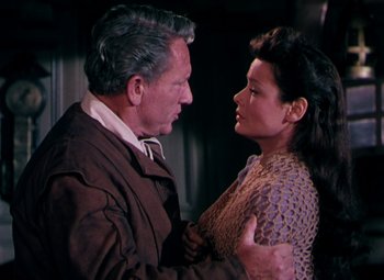 Movie still from “Plymouth Adventure” (1952), directed by Clarence Brown – An older man and a younger woman embracing each other; Medium shot, Over the shoulder angle