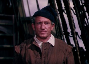 Movie still from “Plymouth Adventure” (1952), directed by Clarence Brown – A man wearing a brown jacket and a blue hat; Close Up shot, High angle