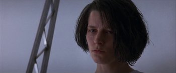 Movie still from “Point of No Return” (1993), directed by John Badham – A person with short black hair; Close Up shot, Low angle