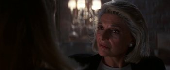 Movie still from “Point of No Return” (1993), directed by John Badham – An older woman with white hair looking into a mirror; Close Up shot, Over the shoulder angle
