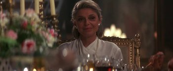 Movie still from “Point of No Return” (1993), directed by John Badham – A woman sitting in front of a glass of red wine; Close Up shot, Over the shoulder angle