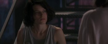 Movie still from “Point of No Return” (1993), directed by John Badham – A woman that is sitting in a room; Close Up shot, Low angle