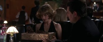 Movie still from “Point of No Return” (1993), directed by John Badham – A man and a woman sitting at a dinner table; Close Up shot, Over the shoulder angle
