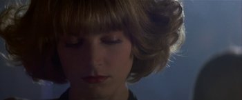 Movie still from “Point of No Return” (1993), directed by John Badham – A woman's face with her eyes closed; Close Up shot, Low angle