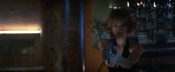 Movie still from “Point of No Return” (1993), directed by John Badham – A woman holding a gun in a room; Close Up shot, Low angle