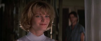 Movie still from “Point of No Return” (1993), directed by John Badham – A person wearing a white shirt; Close Up shot, Low angle