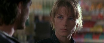 Movie still from “Point of No Return” (1993), directed by John Badham – A person wearing a black shirt; Close Up shot, Over the shoulder angle