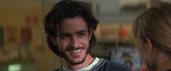 Movie still from “Point of No Return” (1993), directed by John Badham – A person with long black hair; Close Up shot, Over the shoulder angle