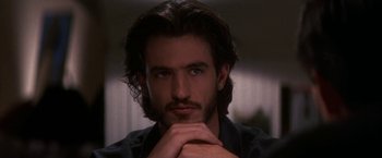 Movie still from “Point of No Return” (1993), directed by John Badham – A person with long dark hair; Close Up shot, Low angle