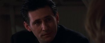 Movie still from “Point of No Return” (1993), directed by John Badham – A person sitting down with his eyes wide open; Close Up shot, Low angle