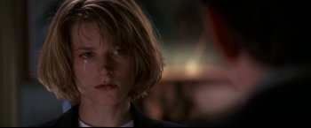 Movie still from “Point of No Return” (1993), directed by John Badham – A person with short hair; Close Up shot, Over the shoulder angle