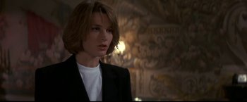 Movie still from “Point of No Return” (1993), directed by John Badham – A woman with short hair wearing a suit; Close Up shot, Low angle