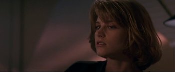 Movie still from “Point of No Return” (1993), directed by John Badham – A person wearing a black shirt; Close Up shot, Low angle