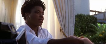 Movie still from “Point of No Return” (1993), directed by John Badham – A woman sitting in front of a window with curtains; Close Up shot, Low angle