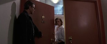 Movie still from “Point of No Return” (1993), directed by John Badham – A man and a woman standing in front of a door; Medium shot, Over the shoulder angle