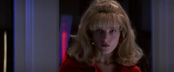 Movie still from “Point of No Return” (1993), directed by John Badham – A woman with blonde hair and blue eyes wearing a red shirt; Close Up shot, Low angle