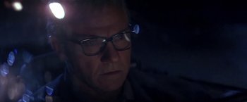 Movie still from “Point of No Return” (1993), directed by John Badham – A person wearing glasses; Close Up shot, Low angle