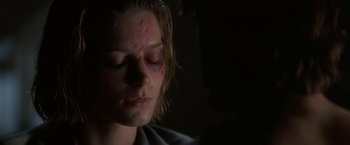Movie still from “Point of No Return” (1993), directed by John Badham – A woman with a bruised face and eyes; Close Up shot, Over the shoulder angle