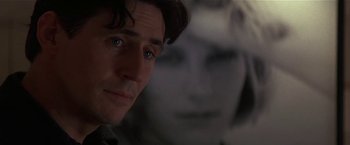 Movie still from “Point of No Return” (1993), directed by John Badham – A man's face in a dark room; Close Up shot, Over the shoulder angle