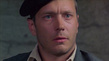 Movie still from “Poison” (1991), directed by Todd Haynes – A person wearing a hat and looking at the camera; Close Up shot, High angle