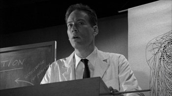 Movie still from “Poison” (1991), directed by Todd Haynes – Black and white photograph of a man wearing a lab coat; Close Up shot, Low angle