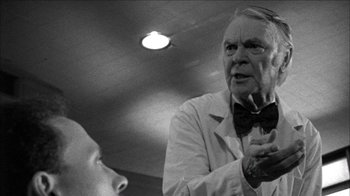 Movie still from “Poison” (1991), directed by Todd Haynes – An older man wearing a bow tie talking to a younger man; Close Up shot, Low angle