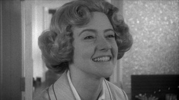 Movie still from “Poison” (1991), directed by Todd Haynes – An old photo of a woman smiling for the camera; Close Up shot, Over the shoulder angle