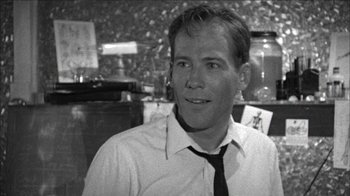 Movie still from “Poison” (1991), directed by Todd Haynes – Black and white photograph of a man wearing a tie; Close Up shot, Low angle