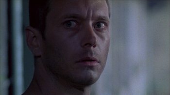 Movie still from “Poison” (1991), directed by Todd Haynes – A man's face in the dark; Close Up shot, Over the shoulder angle
