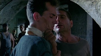 Movie still from “Poison” (1991), directed by Todd Haynes – A man looking at his reflection in a mirror; Close Up shot, Low angle