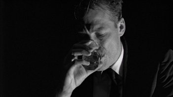 Movie still from “Poison” (1991), directed by Todd Haynes – A black and white photo of a man eating a donut; Close Up shot, Low angle