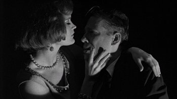 Movie still from “Poison” (1991), directed by Todd Haynes – A man and a woman are kissing in the dark; Close Up shot, Low angle