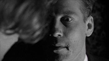 Movie still from “Poison” (1991), directed by Todd Haynes – A black and white photo of a man's face; Extreme Close Up shot, Over the shoulder angle