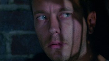 Movie still from “Poison” (1991), directed by Todd Haynes – A man's face with blue eyes; Close Up shot, Low angle