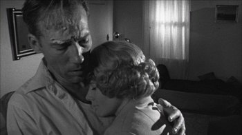 Movie still from “Poison” (1991), directed by Todd Haynes – An old photo of a man and a woman hugging; Extreme Close Up shot, Low angle