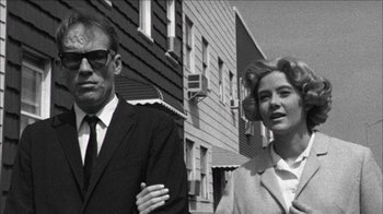 Movie still from “Poison” (1991), directed by Todd Haynes – An older man standing next to an older woman; Close Up shot, Low angle