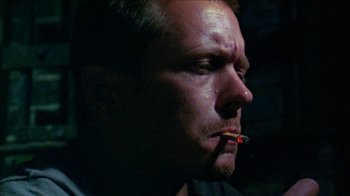 Movie still from “Poison” (1991), directed by Todd Haynes – A person smoking a cigarette; Close Up shot, Low angle